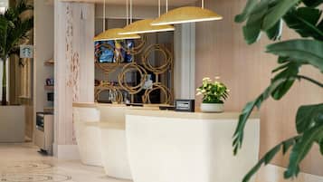 A hotel reception area with a modern design, featuring a white reception desk, a sign indicating 'Hilton Honors', and a decorative wall with circular patterns.