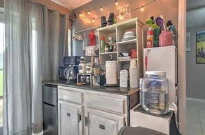 Modern kitchen with stainless steel appliances, oven, and microwave. Enjoy cooking with a coffee maker, kettle, and ample counter space.