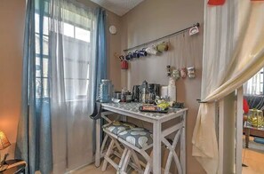 Functional kitchen area with a small table and bench, perfect for meal preparation.