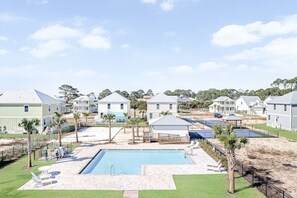 A residential area with houses, a swimming pool, and solar panels.