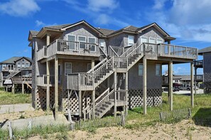 A multi-story house with a balcony and a staircase.