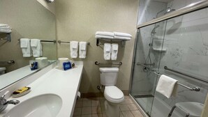 A modern bathroom with a sink, toilet, and glass-enclosed shower. - Surestay Hotel By Best Western Eureka (Eureka)