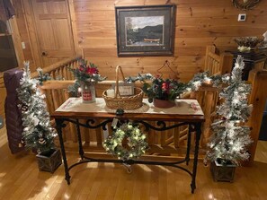 Cozy room with a wooden bench, table, and festive decor.