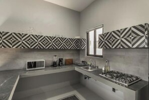 Fridge, microwave, coffee/tea maker, cookware/dishes/utensils