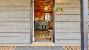 A wooden exterior with a door leading to a kitchen area.