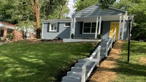 A residential house with a front yard, a concrete pathway leading to the front door, and a small porch. - Charming 3-Bed/1-Bath Home in Hyattsville, MD! (Hyattsville)