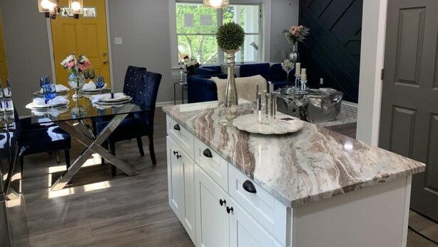 A modern kitchen with a marble countertop, white cabinetry, and pendant lighting. - Charming 3-Bed/1-Bath Home in Hyattsville, MD! (Hyattsville)