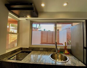 Fridge, microwave, coffee/tea maker, cookware/dishes/utensils