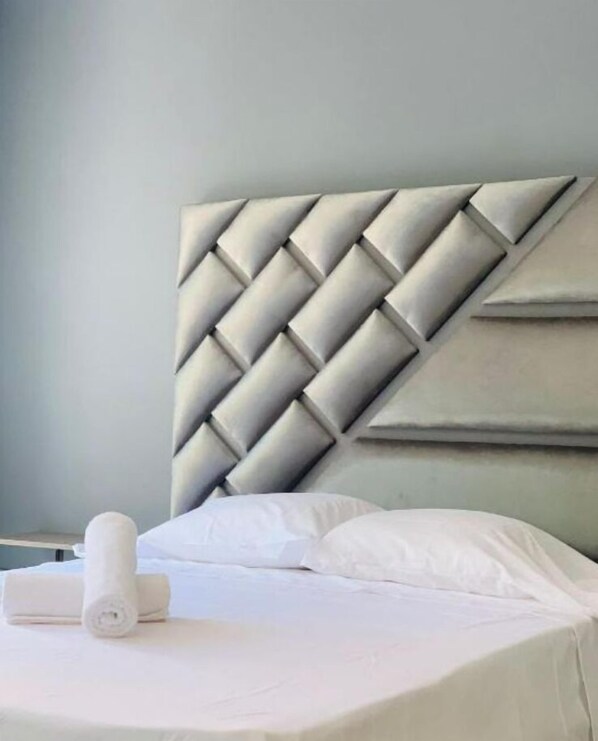 A bed with a headboard featuring a geometric pattern.