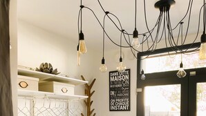 A modern interior with a coat rack, a radiator, and a sign in French. - Cosy duplex - between lakes and mountains - NO PARTIES ALLOWED (Fillinges)