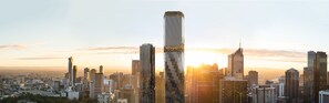 A cityscape with modern skyscrapers and a prominent tall building with a unique design. - The Ritz-Carlton, Melbourne (Melbourne)