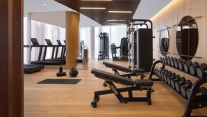 A modern gym with treadmills, weight machines, and a variety of weights. - Tirana Marriott (Tirana)