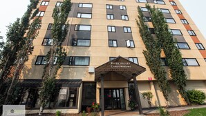 A multi-story building with a sign reading "River Valley Condominiums."