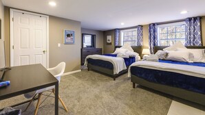 A hotel room with two beds, a desk, a chair, and a door. - Cozy Newport Cottage Near Stadiums & Downtown (Newport)