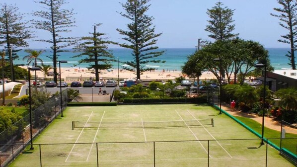 Enjoy a game of tennis with a stunning ocean view.