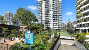 Enjoy stunning views of the surrounding landscape from the hotel's high-rise building, surrounded by lush greenery and palm trees.