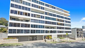 A multi-story building with large windows and a flat facade. - Goodwin Towers 10, Burleigh Heads. (Gold Coast)