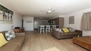 Relax in the cozy living room with a sofa, armchair, and side table.