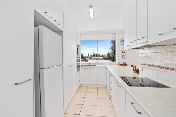 Prepare meals with ease in this kitchen featuring a stovetop and ample counter space.