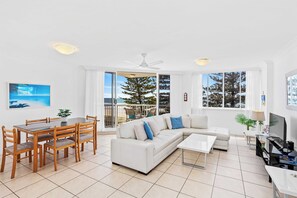 Relax in this cozy living space with a sofa, dining table, and flat-screen TV.