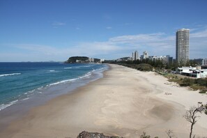Enjoy a serene beach experience with gentle waves lapping at the shore.