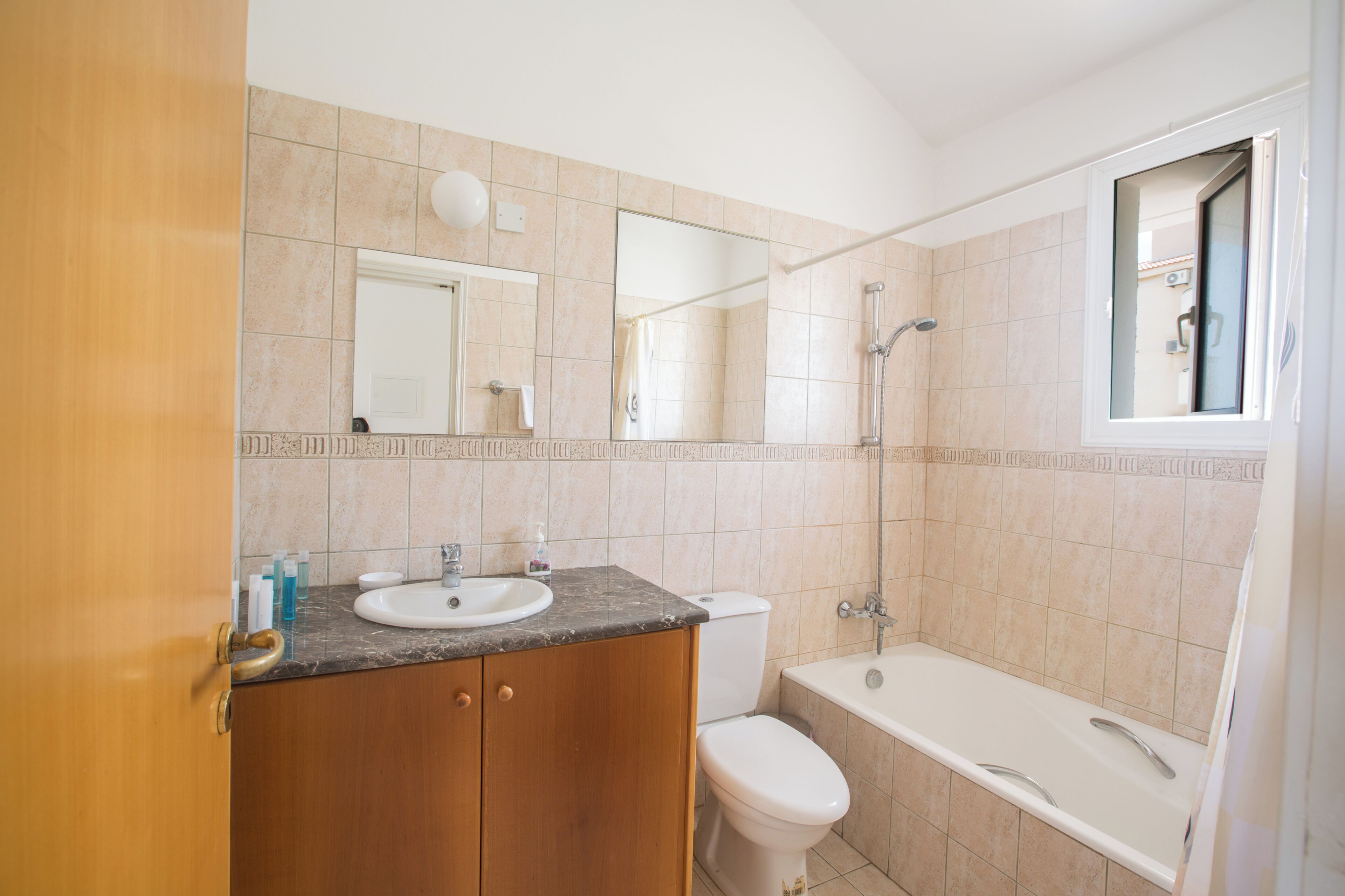 A bathroom with a sink, toilet, and bathtub.