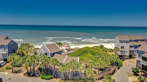 A coastal residential area with houses, a beach, and a clear blue sky. - Gulf Front-Unobstructed Views! Book Now! (Port St. Joe)