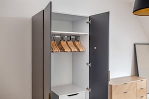 Wardrobe with shelf and hanging rod for clothes.