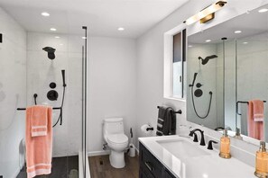 Bathtub, hair dryer, towels, shampoo