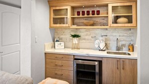 A compact kitchen with wooden cabinets, a built-in microwave, and a sink. - Best Panoramic Views in Sedona, Hot Tub + Firepit! (Sedona)