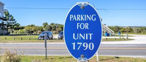 A blue parking sign for Unit 1790.