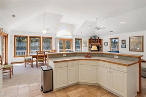 Enjoy meals in this well-equipped kitchen with a large island, sink, and ample countertop space.
