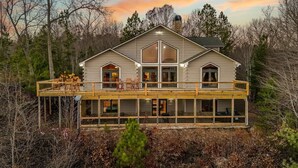 A log cabin with a balcony, large windows, and a chimney. - Carter`s Lake Overlook | Ellijay, Ga (Ellijay)