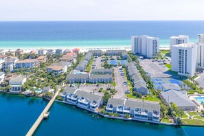 A coastal residential area with a marina, beachfront, and high-rise buildings.