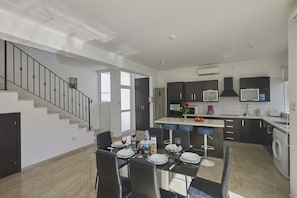 Enjoy a spacious living area and separate dining space in this apartment, featuring a kitchen with oven and microwave.