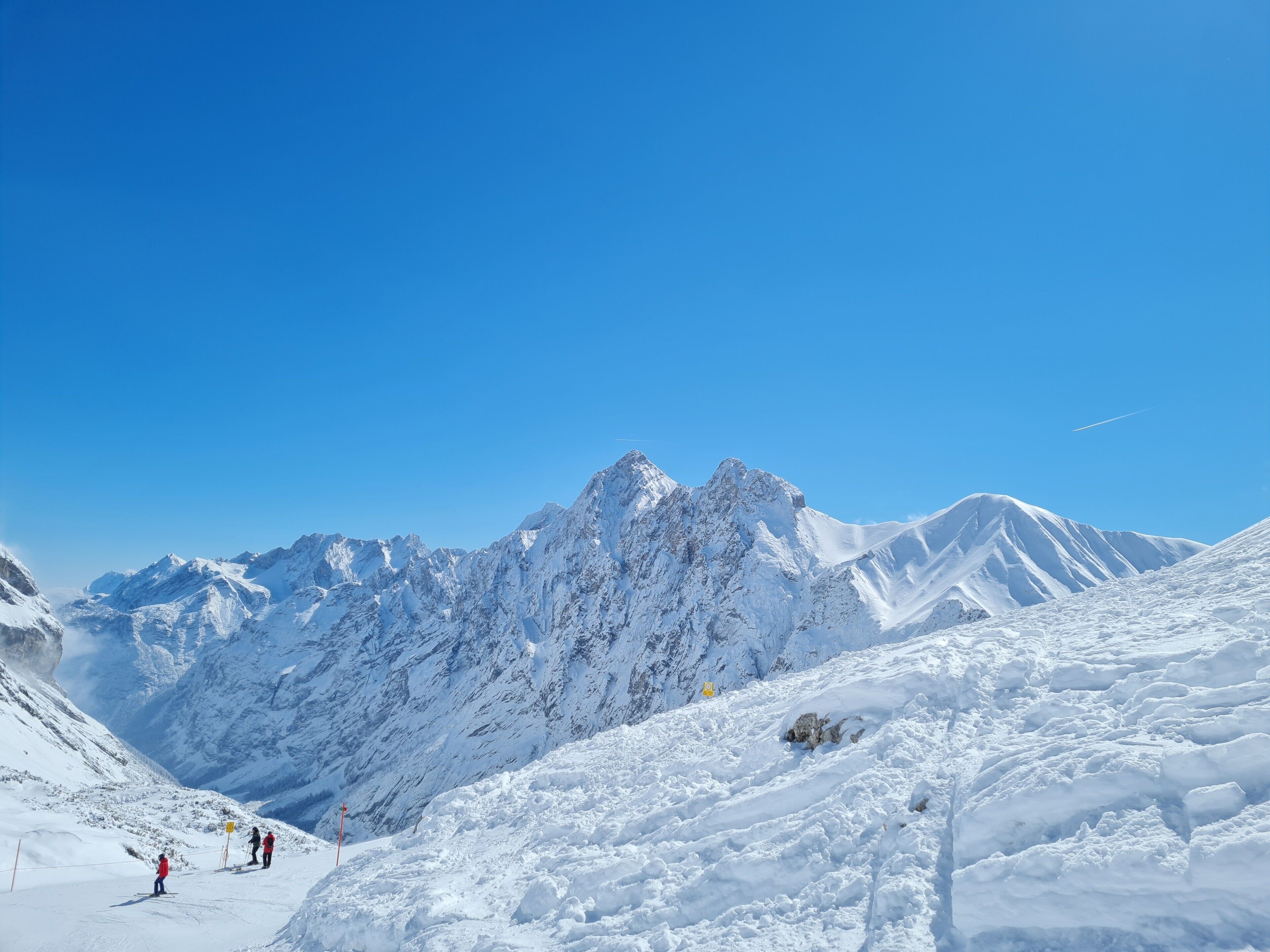 A snowy mountain landscape with clear skies.
