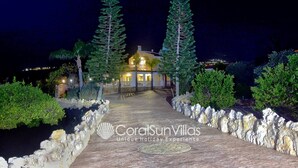A house with a pathway leading to it, surrounded by trees and a body of water. - Fabulous Villa In Coral Bay Near Beach, Amenities (Peyia)