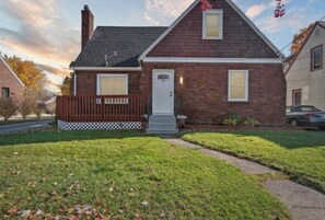 Classic two-story home with a central entrance and a well-manicured lawn.