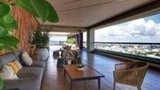 A modern interior with a wooden floor, a sofa, a coffee table, and a large window offering a view of the city. - Goistay Discover Unparalleled Elegance in the Clouds A Luxury Apartment in th (Santo Domingo)