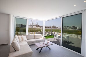 Relax in a serene living area with a comfortable sofa and expansive views of the surrounding landscape.