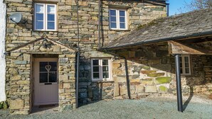 A stone building with a white door, two windows, and a small porch area. - Duddon View  -  Duddon Valley, Lake District (Dog-friendly) (Seathwaite)