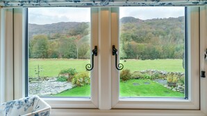 A window with a view of a green landscape and hills. - Riverside Cottage  - Duddon Valley (Dog-friendly) (Seathwaite)