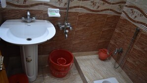 A bathroom with a sink, toilet, and shower. - Marwa Hotel and Restaurant (Abbottabad)