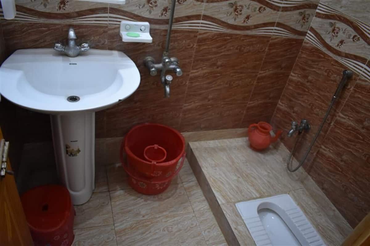 A bathroom with a sink, toilet, and shower.