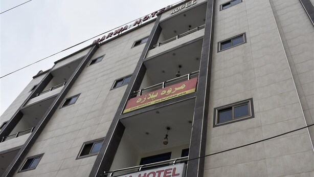 A multi-story building with balconies and a sign indicating it is the Marwa Hotel Restaurant. - Marwa Hotel and Restaurant (Abbottabad)