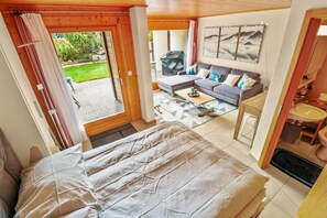 A bedroom with a bed, a sofa, a coffee table, and a bathroom with a sink and toilet. - Superb apartment with free covered parking (Lens)
