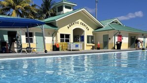 An outdoor swimming pool with a building labeled "AQUATIC CENTER" in the background.