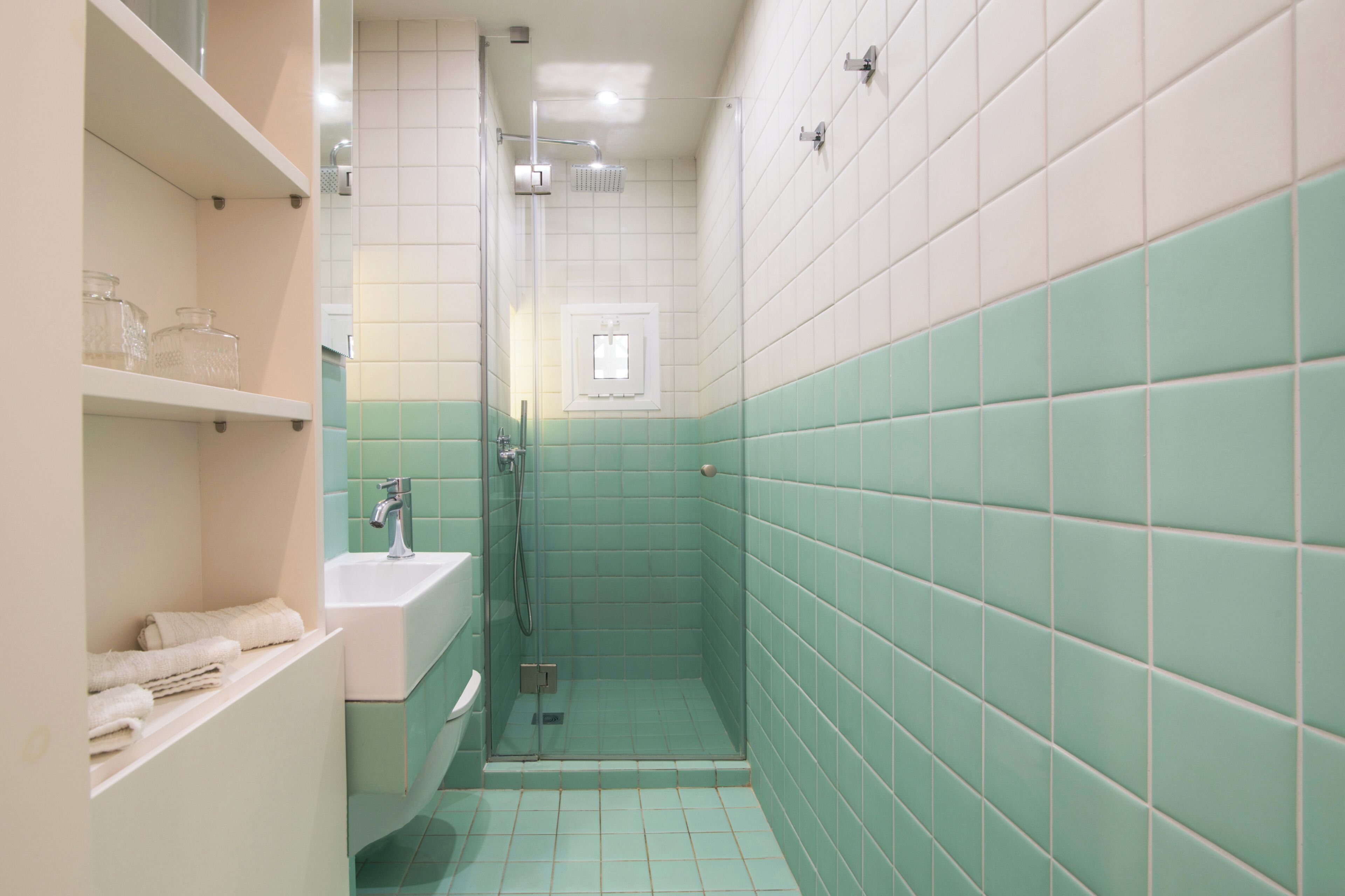 A bathroom with a sink, a shower, and a toilet.