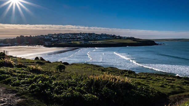 A coastal view with a beach, a village, and a clear sky. - The Lookout (Wadebridge)