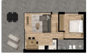 Un plan d’aménagement de chambre d’hôtel comprenant un lit, un canapé, une table à manger, un coin cuisine et une salle de bain.